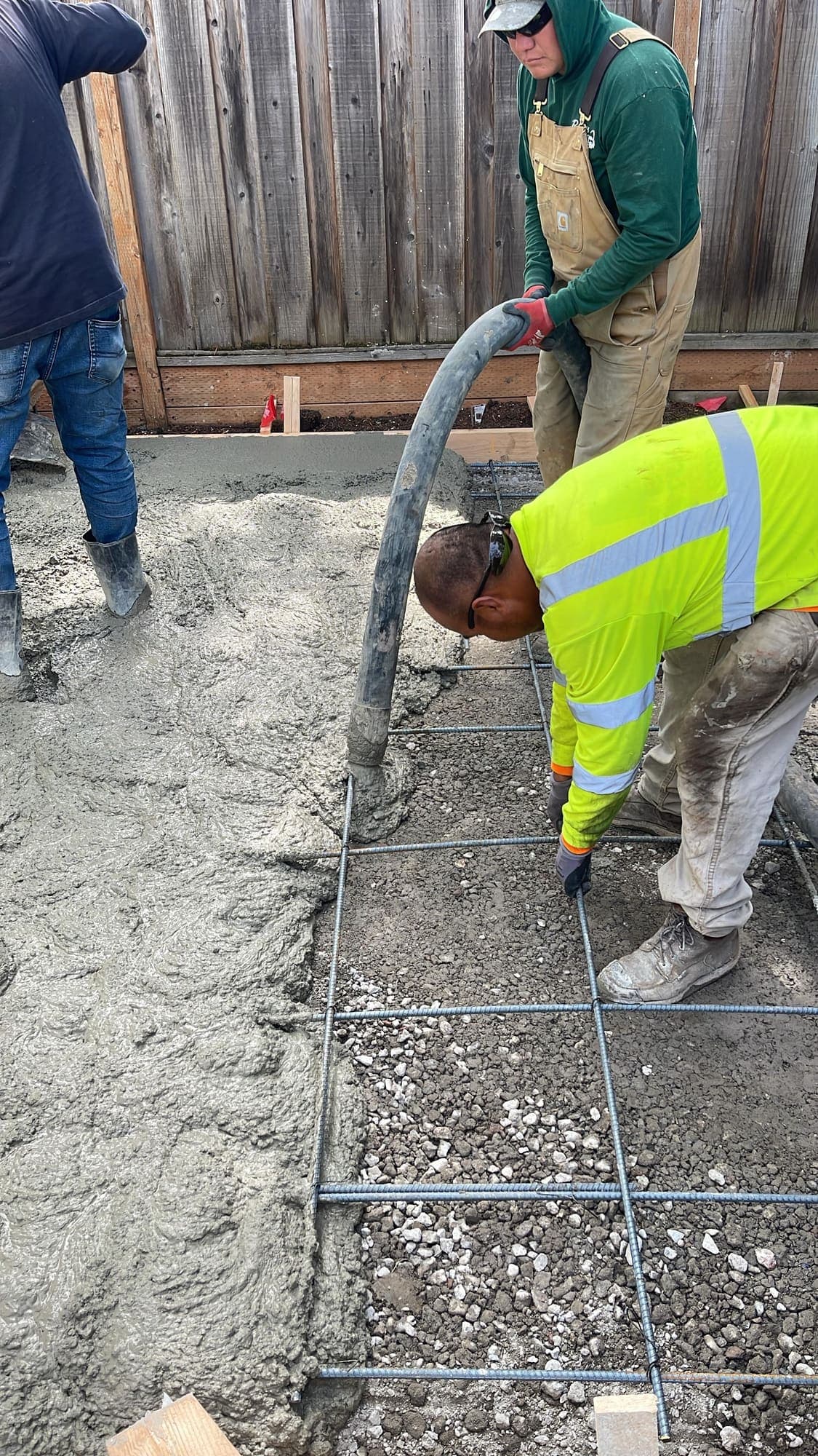 Paragon General Engineering crew in hi-vis placing and finishing a concrete curb and gutter section