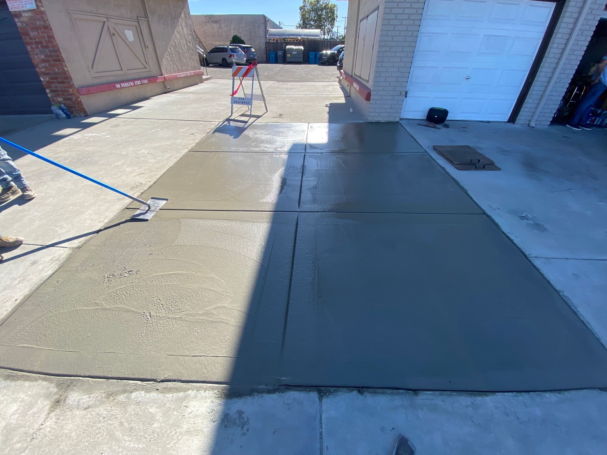 New concrete access walkway poured along a commercial building frontage