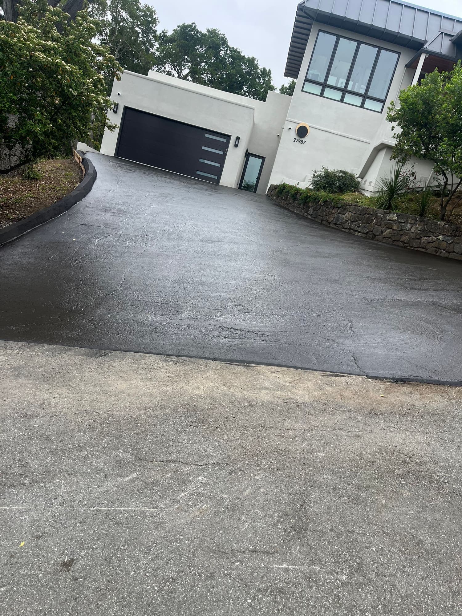 Finished concrete drive and approach at a modern residence